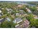 Beautiful aerial view of the property surrounded by mature trees and overlooking the nearby lake at 1020 Mayfield Ave, Winter Park, FL 32789