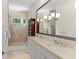 Bright bathroom featuring double sinks, large mirror, and a glass walk-in shower at 1020 Mayfield Ave, Winter Park, FL 32789
