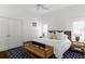 Bright bedroom with white walls, a ceiling fan, and wood accents with large blue pattern rug at 1020 Mayfield Ave, Winter Park, FL 32789