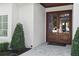 Welcoming entrance with double doors and clean lines, complemented by lush greenery and a stone walkway at 1020 Mayfield Ave, Winter Park, FL 32789