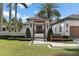 Charming home entrance featuring a pergola with covered walkway, leading to the custom doors and lush landscaping at 1020 Mayfield Ave, Winter Park, FL 32789