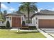 Charming single-story home with lush landscaping, wooden accents, and a welcoming front entrance at 1020 Mayfield Ave, Winter Park, FL 32789