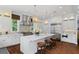 Bright and airy kitchen with a center island, stainless steel appliances, and modern pendant lighting at 1020 Mayfield Ave, Winter Park, FL 32789
