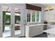 Well-lit kitchen with stainless steel appliances, ample counter space, and glass doors leading to the outdoor patio at 1020 Mayfield Ave, Winter Park, FL 32789