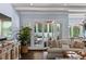 Inviting living area with access to the outdoor living space, featuring a plant, sofa, and hardwood floors at 1020 Mayfield Ave, Winter Park, FL 32789
