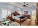 Spacious main bedroom featuring a ceiling fan, hardwood floors, and en-suite bathroom at 1020 Mayfield Ave, Winter Park, FL 32789