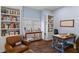Bright office with hardwood floors, lots of shelving and storage, and a comfortable chair at 1020 Mayfield Ave, Winter Park, FL 32789