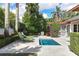 Pool with manicured greenery, lounge chairs, and a partial view of the house at 1020 Mayfield Ave, Winter Park, FL 32789