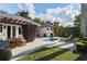 Backyard pool featuring a patio with outdoor seating, well-maintained grass, and landscaping at 1020 Mayfield Ave, Winter Park, FL 32789