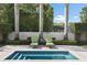 Backyard pool area featuring lounge chairs, manicured landscaping, and tall trees at 1020 Mayfield Ave, Winter Park, FL 32789