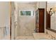 Walk-in shower with tiled walls, a glass door, and a bench at 1020 Mayfield Ave, Winter Park, FL 32789