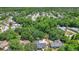 Wide aerial view showing the property and the surrounding lush, green landscape and neighborhood at 1025 Winter Springs Blvd, Winter Springs, FL 32708