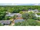 Aerial view of a home with mature trees surrounding it and a screened-in porch at 1025 Winter Springs Blvd, Winter Springs, FL 32708