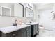 Bathroom featuring dual vanities with modern fixtures and a tiled walk-in shower at 1025 Winter Springs Blvd, Winter Springs, FL 32708