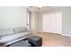 This bedroom boasts hardwood floors, a sofa, ottoman, closet, and great natural lighting at 1025 Winter Springs Blvd, Winter Springs, FL 32708