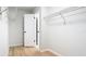 White open closet with wooden floors, shelving on walls, and a door to a room at 1025 Winter Springs Blvd, Winter Springs, FL 32708