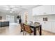 Open-concept kitchen and dining area with stainless appliances and a modern table set at 1025 Winter Springs Blvd, Winter Springs, FL 32708