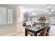 Modern dining area connected to a kitchen featuring stainless appliances, white cabinets, and natural light at 1025 Winter Springs Blvd, Winter Springs, FL 32708