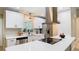 Renovated kitchen featuring stainless appliances, white cabinets, and a modern range hood at 1025 Winter Springs Blvd, Winter Springs, FL 32708