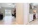 Open-concept living area with wood floors, flowing into a bright kitchen with stainless appliances and white cabinets at 1025 Winter Springs Blvd, Winter Springs, FL 32708