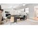 Open living space with a fireplace and modern kitchen featuring white cabinets and stainless steel appliances at 1025 Winter Springs Blvd, Winter Springs, FL 32708
