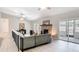 Spacious living room with a brick fireplace, light wood floors, and access to the backyard at 1025 Winter Springs Blvd, Winter Springs, FL 32708