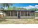Wide view of the screened-in porch from the backyard at 1025 Winter Springs Blvd, Winter Springs, FL 32708