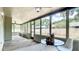 Spacious sunroom features many windows, ceiling fans, and space to enjoy the outdoors from inside the home at 1025 Winter Springs Blvd, Winter Springs, FL 32708