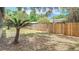 Spacious yard featuring mature trees and a tall wood fence at 1025 Winter Springs Blvd, Winter Springs, FL 32708