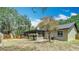 Backyard featuring a mature shade tree, an AC unit, and a screened-in porch at 1025 Winter Springs Blvd, Winter Springs, FL 32708