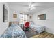 Bedroom with two twin beds, a ceiling fan, and desk at 1065 Jason Ridge Ct, Kissimmee, FL 34747