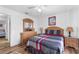 Bedroom with wood floors, a wooden bed frame, and two nightstands at 1065 Jason Ridge Ct, Kissimmee, FL 34747