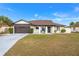 Charming single-story home with a well-maintained lawn, two-car garage, and inviting entryway at 1065 Jason Ridge Ct, Kissimmee, FL 34747