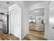 Bright hallway with wood floors leading to the living room and stainless steel appliances at 1065 Jason Ridge Ct, Kissimmee, FL 34747