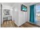 Hallway features wood floors, bright white walls, and leads to a bathroom at 1065 Jason Ridge Ct, Kissimmee, FL 34747