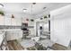 Eat-in kitchen featuring stainless steel appliances, white cabinets, and glass-top dining table at 1065 Jason Ridge Ct, Kissimmee, FL 34747