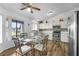 Eat-in kitchen featuring stainless steel appliances, white cabinets, and glass-top dining table at 1065 Jason Ridge Ct, Kissimmee, FL 34747