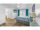 Bright main bedroom with wood floors, a ceiling fan, and sliding glass doors to the backyard at 1065 Jason Ridge Ct, Kissimmee, FL 34747