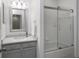 The bathroom features a vanity with drawers and a shower and bathtub combo with sliding glass doors at 1068 Lake Baldwin Ln, Orlando, FL 32814