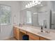 Bright bathroom with a spacious vanity, double sinks, and a glass-enclosed shower at 1068 Lake Baldwin Ln, Orlando, FL 32814