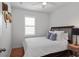 Bedroom with a queen bed, hardwood flooring, and a side table with a lamp at 1068 Lake Baldwin Ln, Orlando, FL 32814