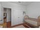 Bright Bedroom features wood floors, closet, and a cozy crib, perfect for a new baby at 1068 Lake Baldwin Ln, Orlando, FL 32814