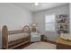 Charming Bedroom with a crib, glider, and natural light through a large window at 1068 Lake Baldwin Ln, Orlando, FL 32814