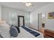 Bedroom with a large mirror and hardwood flooring, illuminated by natural light at 1068 Lake Baldwin Ln, Orlando, FL 32814