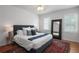 Cozy bedroom with a comfortable bed, decorative rug, and ample natural light from shuttered windows at 1068 Lake Baldwin Ln, Orlando, FL 32814