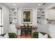 Dining area with built-in shelving, a wooden table, and stylish decor at 1068 Lake Baldwin Ln, Orlando, FL 32814