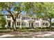 Charming two-story townhome featuring a well-maintained lawn and beautiful mature shade trees at 1068 Lake Baldwin Ln, Orlando, FL 32814