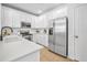 Well-lit kitchen featuring stainless steel appliances, white countertops, and ample cabinet space at 1068 Lake Baldwin Ln, Orlando, FL 32814