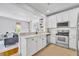 Modern kitchen with white cabinets, stainless steel appliances, and an open layout at 1068 Lake Baldwin Ln, Orlando, FL 32814