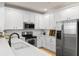 Modern kitchen features stainless steel appliances, granite countertops, and white cabinets at 1068 Lake Baldwin Ln, Orlando, FL 32814
